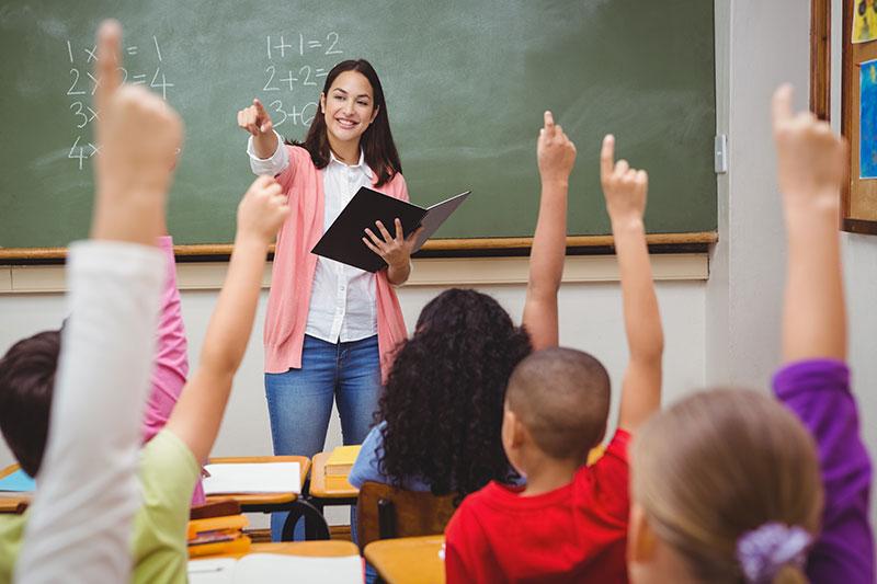 Students learning in class at New East West Academy
